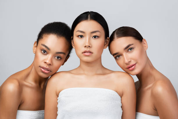 istock Three Sensual Women Posing Wrapped In White Towels, Studio Shot 1271729457