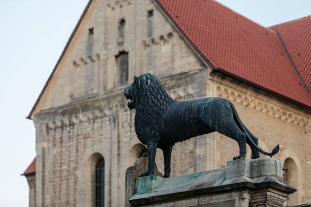 Bronze statue of Braunschweig lion in Germany Bronze statue and close-up of historical church building braunschweig photos stock pictures, royalty-free photos & images