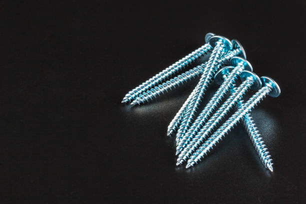 istock screws on black background. close up. creative photo. 1271734280