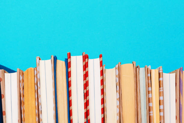 istock books on a blue background. creative photo. 1271736159