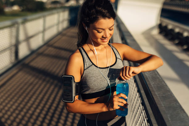 istock Sportswoman resting and hydrating on the bridge 1271736198