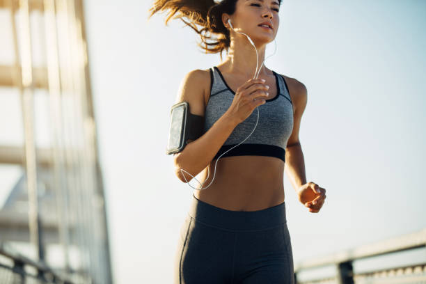 istock Female jogger running over the bridge 1271736214