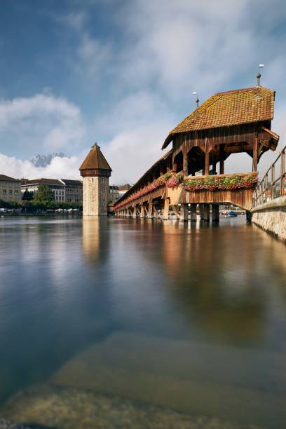 Chapel Bridge at sunny day. Famous landmark against Mount Pilatus in Lucerne, Switzerland.