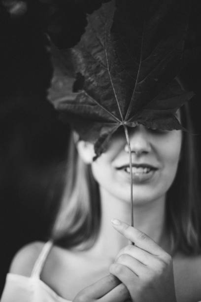 istock A young girl holds a maple leaf in front of her face. 1271738381