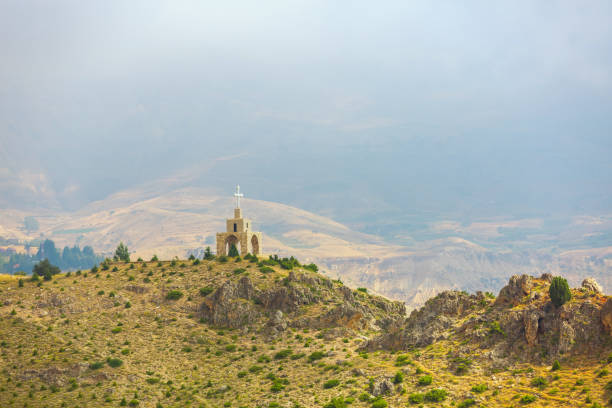 Chapel and cross in the mountains in Lebanon Chapel and cross in the mountains in Lebanon. Panoramic view of the Kadisha Valley. The place of the ancient Christian community. Beautiful Lebanese mountain landscape monastery religion spirituality river stock pictures, royalty-free photos & images