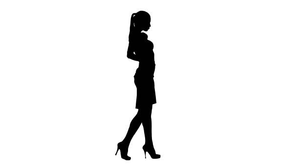 istock Silhouette Beautiful young woman in elegant outfit walking, holding hands on hips 1271738936