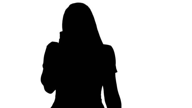 istock Silhouette Young Woman Talking to Someone on her Mobile Phone 1271739484