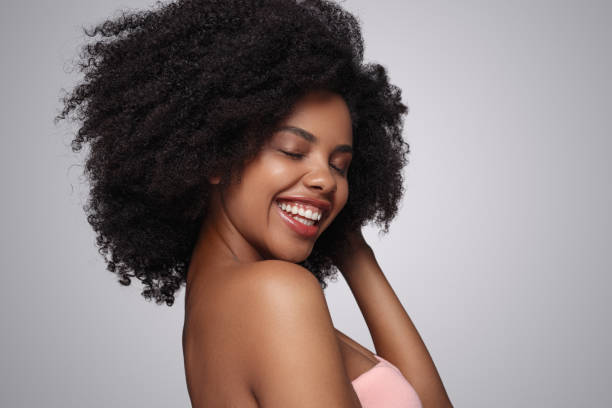 istock Cheerful black woman touching hair 1271739689