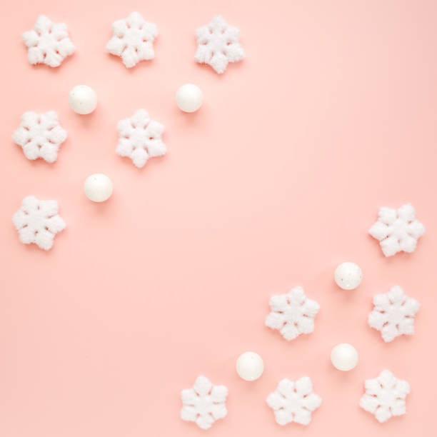istock Christmas frame with white christmas snowflakes on pink background. Christmas composition, wallpaper. Flat lay, top view 1271741511