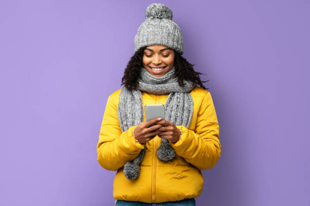 istock African Girl With Smartphone Texting Standing Over Purple Studio Background 1271741642
