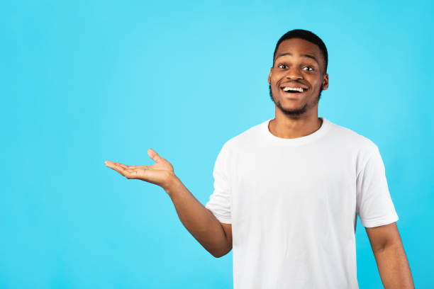 istock African American Guy Showing Free Space Gesturing Aside, Blue Background 1271741751