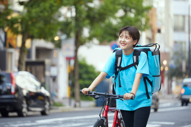 istock A woman delivering food by bicycle 1271741999