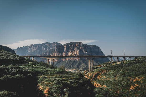 A stone bridge in the mountains under the sky