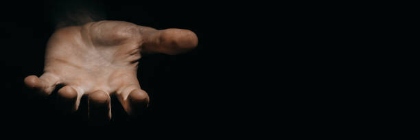 istock asking hands of a working man in the dark 1271745520