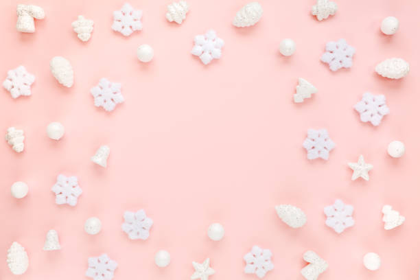 istock Christmas frame with white christmas snowflakes on pink background. Christmas composition, wallpaper. Flat lay, top view 1271746670
