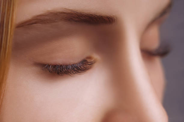 istock Eyelash Extension Procedure. Woman Eye with Long Eyelashes. Close up, selective focus 1271746738