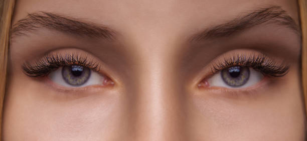istock Eyelash Extension Procedure. Woman Eye with Long Eyelashes. Close up, selective focus 1271746867