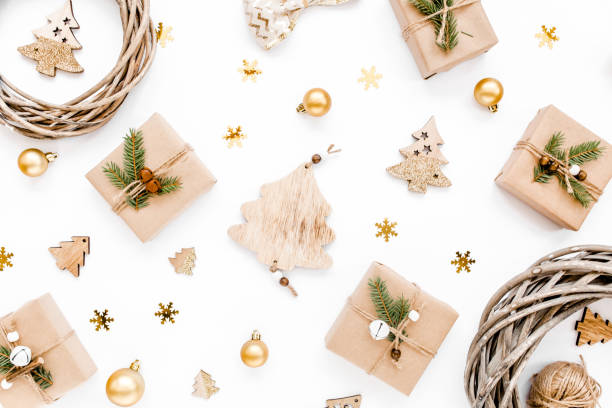 istock Christmas pattern made in gold colors and craft boxes on white background with empty. Holiday and celebration concept. Top view. Flat lay 1271747024