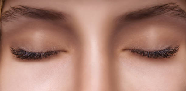 istock Eyelash Extension Procedure. Woman Eye with Long Eyelashes. Close up, selective focus 1271747076