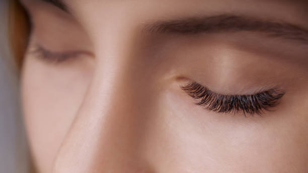 istock Eyelash Extension Procedure. Woman Eye with Long Eyelashes. Close up, selective focus 1271747186