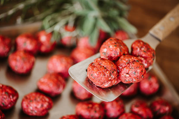 Fresh Raw Black Angus meat balls with spatula