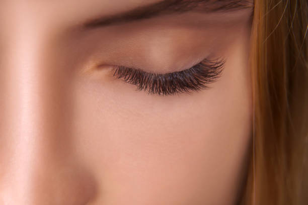 istock Eyelash Extension Procedure. Woman Eye with Long Eyelashes. Close up, selective focus 1271747957