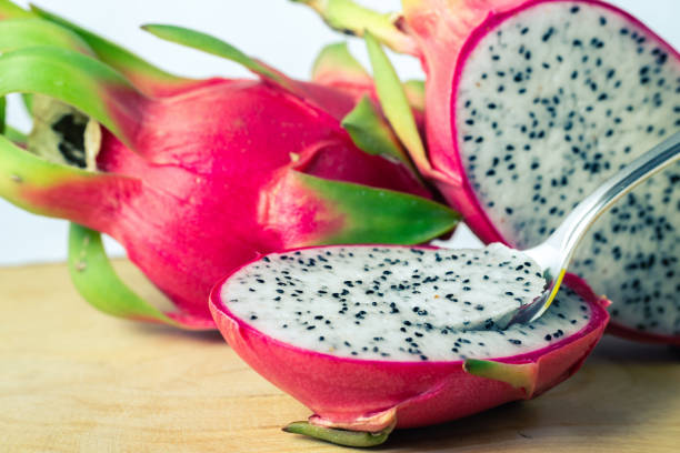 istock eating dragon fruit pitaya and spoon on wooden background 1271747971