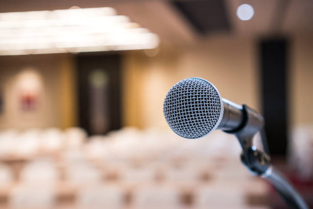 istock Microphones for speech or speaking in seminar Conference room, talking for lecture to audience university, Event light convention hall Background. Business Talk Presentation concept 1271750069