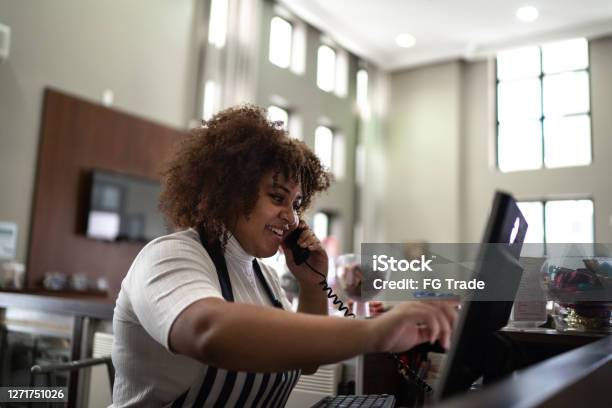 Waitress Registering Clients Order In A Computer At Coffee Shop Stock Photo - Download Image Now