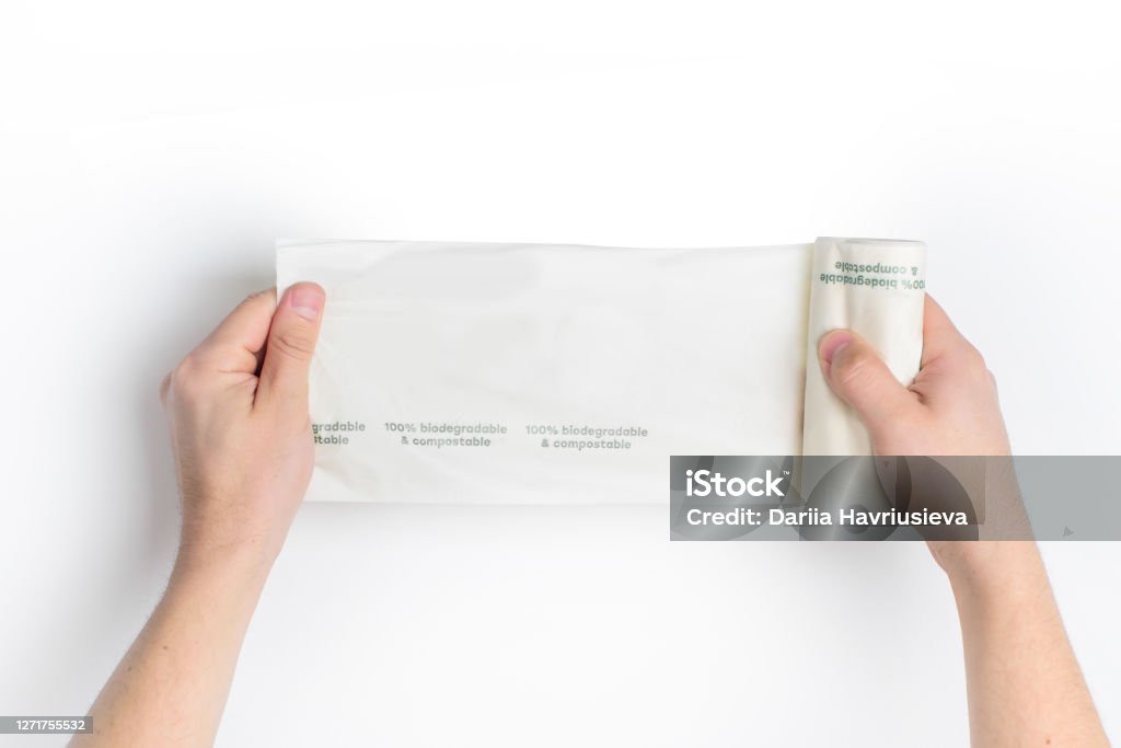 Biodegradable package in the hands. Eco friendly. Biodegradable Stock Photo