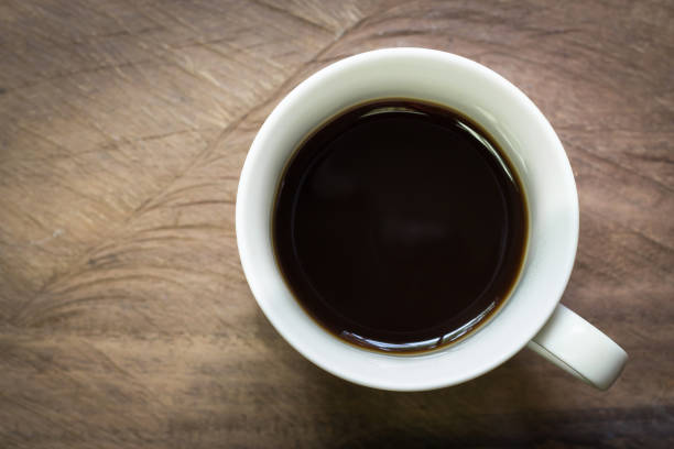 istock Cup of black coffee on wooden table background with copy space. 1271756117