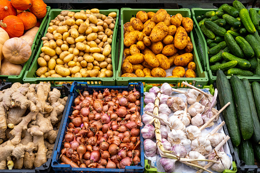 Potatoes, onions and other vegetables for sale at a market