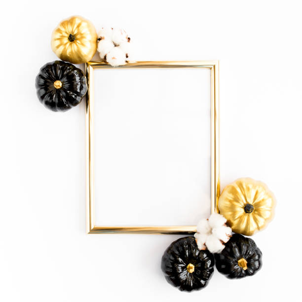 istock Gold frame decorated with black and gold Halloween pumpkin with copy space for text. isolated on white background. Flat lay, top view 1271758792