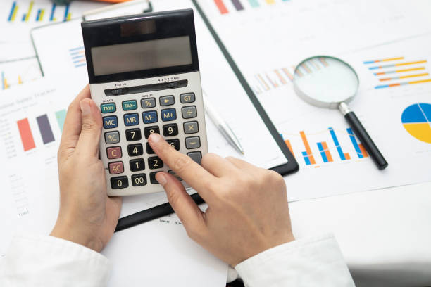 istock Asian accountant working and analyzing financial reports project accounting with chart graph and calculator in modern office,finance and business concept. 1271760179