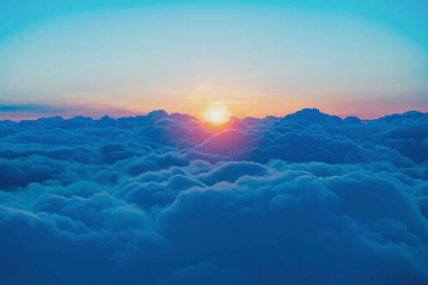 Evening view from the passenger plane Evening sky view from the window of a passenger plane sun above clouds stock pictures, royalty-free photos & images