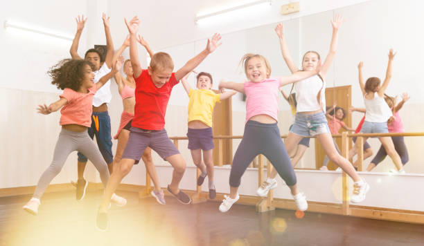 istock Boys and girls jumping in dance studio 1271762840