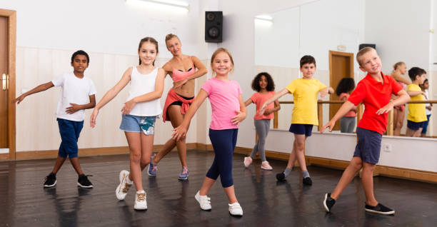 istock Tweens dancing with coach in choreography class 1271762873