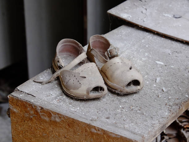 istock Small children's sandals in an abandoned kindergarten in Pripyat. Old children's shoes. 1271763708