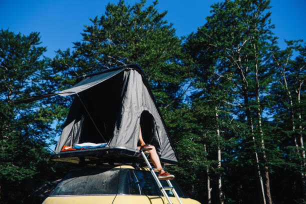 istock Woman relaxing in a car rooftop tent 1271766611