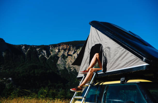 istock Woman relaxing in a car rooftop tent 1271766734