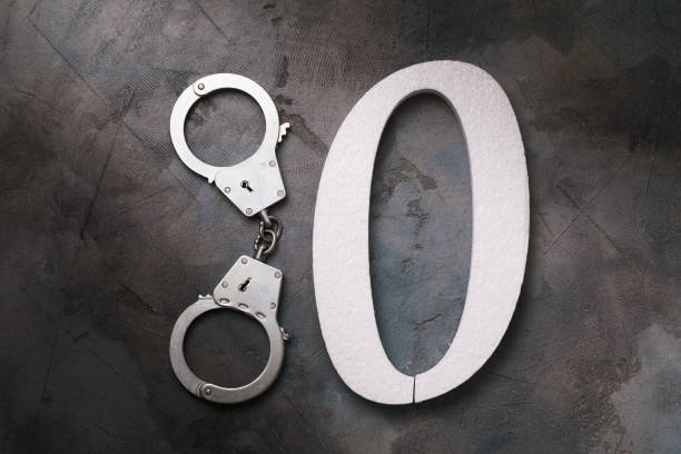istock Handcuffs and number zero on the table, top view. Concept on the topic of zeroing prison terms 1271767105
