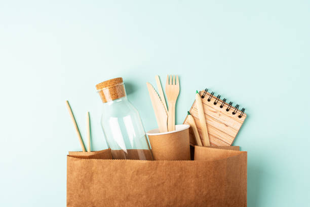 istock Craft bag, glass jar and recycled tableware top view. Flat lay Zero waste, eco friendly, natural organic plastic free concept. Cutlery, earth, biodegradable on mint background with copy space 1271767931