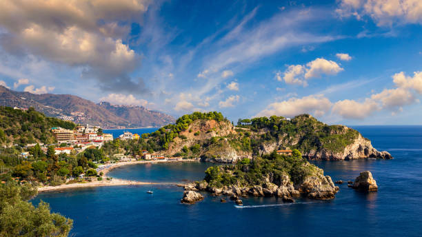 Aerial view of Isola Bella in Taormina, Sicily, Italy. Isola Bella is small island near Taormina, Sicily, Italy. Narrow path connects island to mainland Taormina beach in azure waters of Ionian Sea. Aerial view of Isola Bella in Taormina, Sicily, Italy. Isola Bella is small island near Taormina, Sicily, Italy. Narrow path connects island to mainland Taormina beach in azure waters of Ionian Sea. isola bella taormina stock pictures, royalty-free photos & images