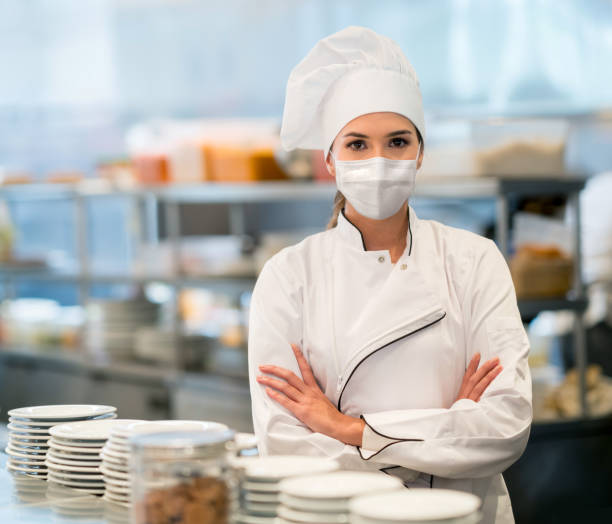 istock Chef working in the kitchen of a restaurant wearing a facemask 1271768783