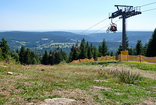 Warmensteinach, Germany - August 22, 2019: The beautiful scenic landscape view from the top of the Ochsenkopf mountain in the Fichtel mountains into the southern direction with the cable car of the southern ski slope