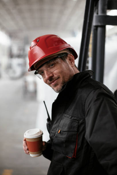 istock Factory worker drinking coffee in factory. 1271769977