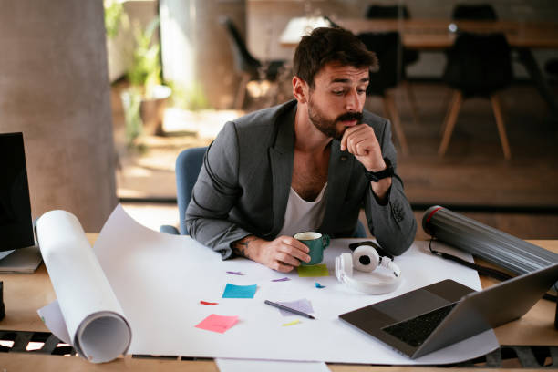 istock Handsome businessman in suit working in the office. 1271772559