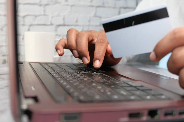 istock man hands holding credit card and using laptop shopping online 1271773904