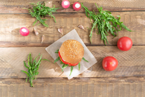 istock Vegetarian burger with chickpea cutlet and vegetables on a blue background. 1271775060