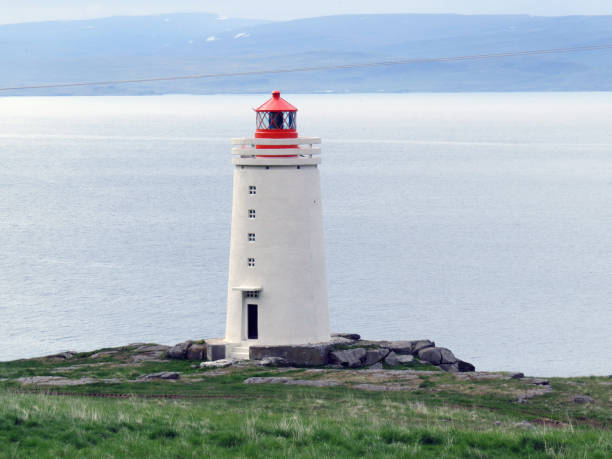 istock A white lighthouse with a red lamp 1271776994